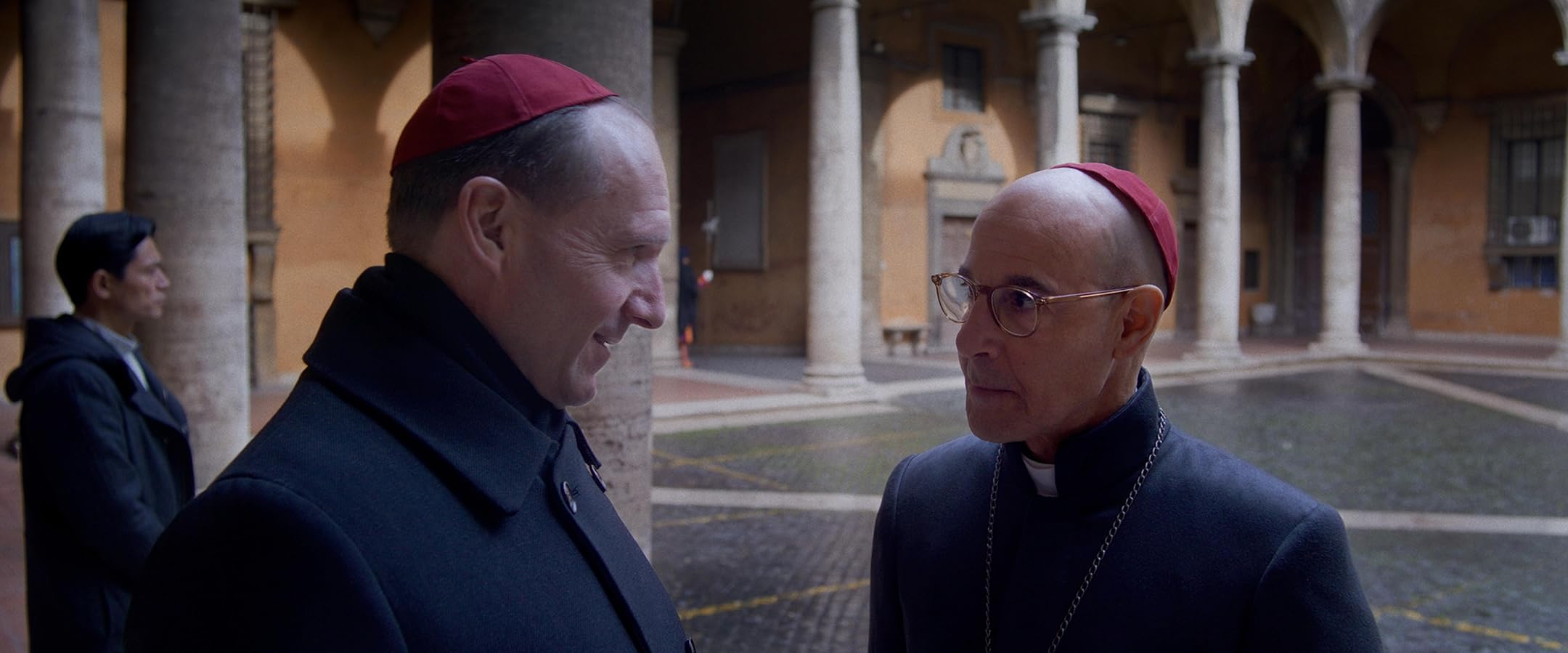 The 50 Best Films of 2024 in the UK - Ralph Fiennes and Stanley Tucci in Conclave (2024).